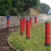 red plastic bollards on pathway