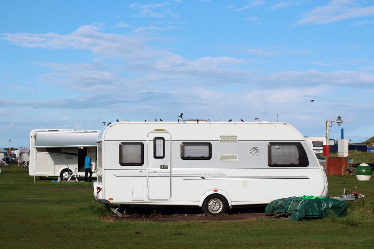 Caravan parked in field with second caravan in background